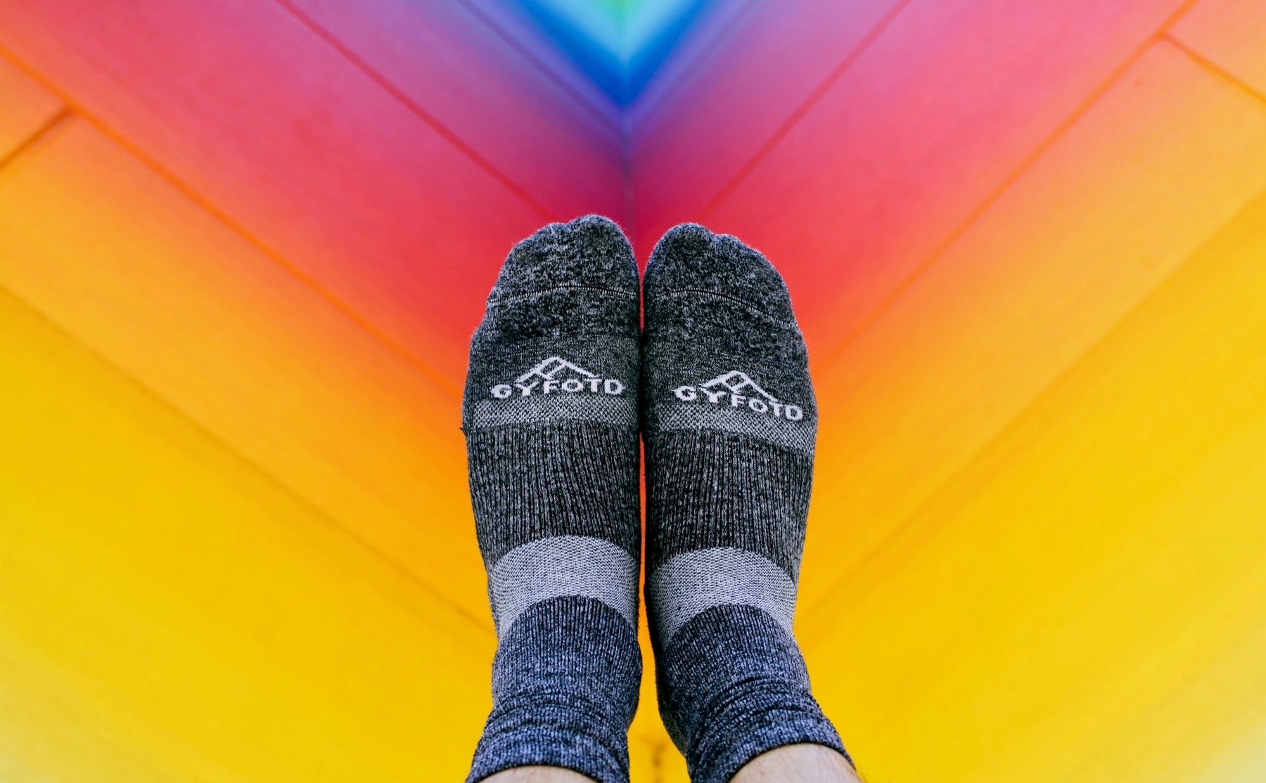 Crew length socks with colorful background.